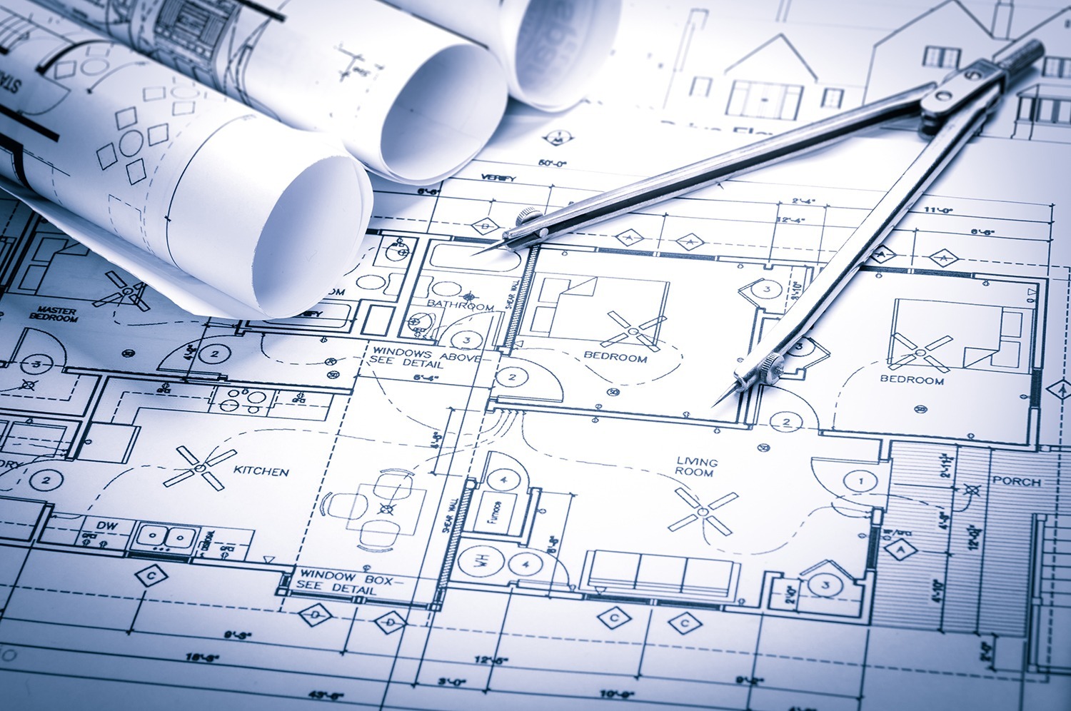 Architectural blueprint with drafting compass showing detailed floor plan